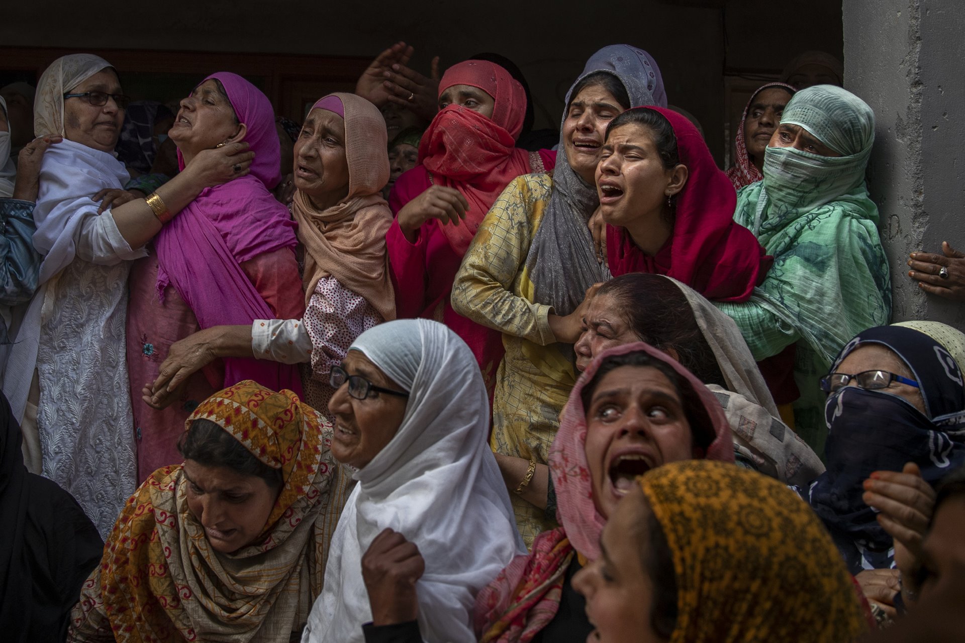 Relatives and neighbors wail during the funeral of Waseem Ahmed, a policeman killed in a shootout, on the outskirts of Srinagar, Indian-administered Kashmir. Two civilians and two police officials were killed in an armed clash the previous day, triggering anti-India protests that accused the police of targeting the civilians.