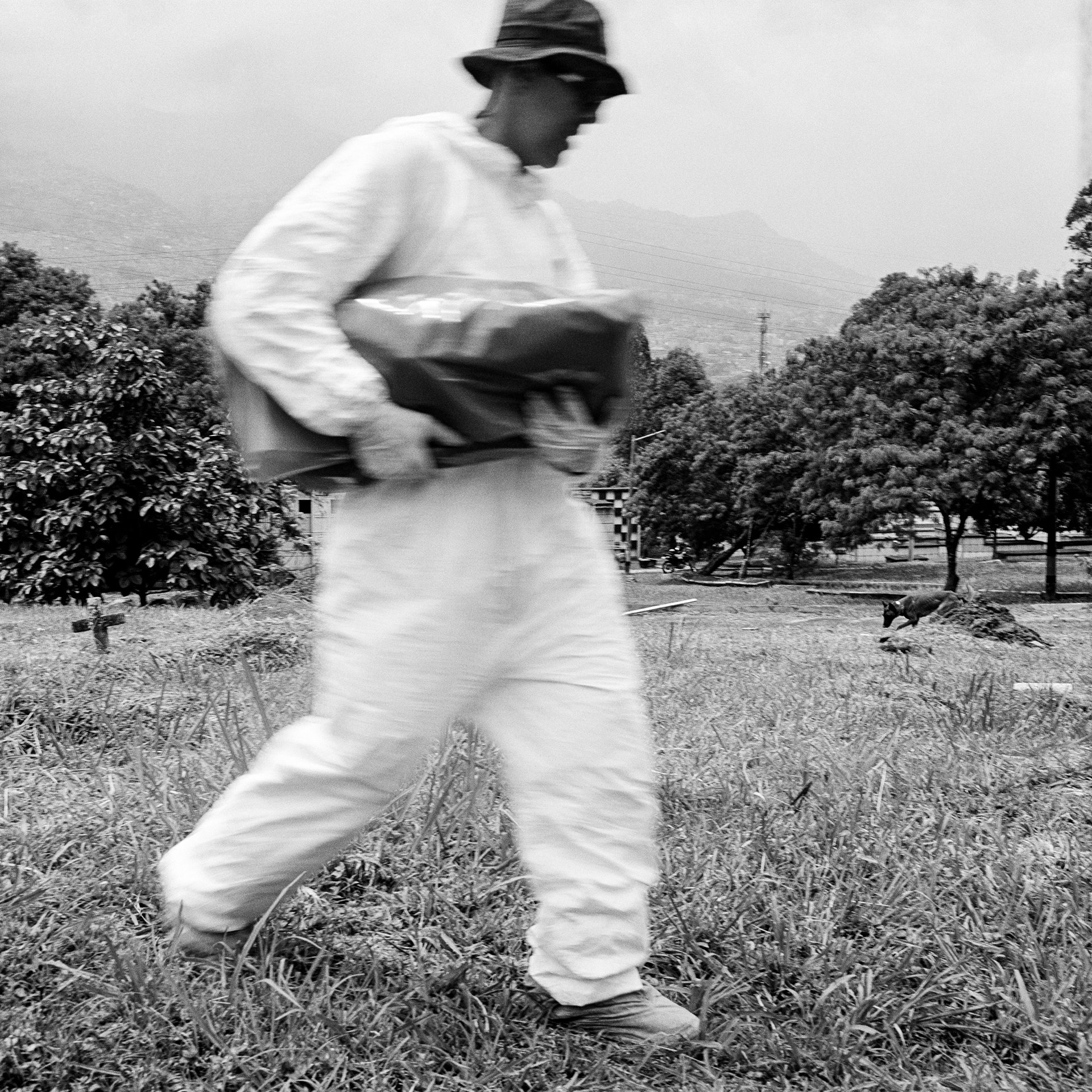 Forensic anthropologist John Fredy Ramirez Santana carries the remains of an unidentified body exhumed in the Jardín Cementerio Universal cemetery in Medellín, during a search for victims of Operación Orion &ndash; an action by security forces against Medellín urban guerillas in 2002. Human rights and civil society organizations claim it to have been a joint operation between State forces and paramilitaries, or at least that there was cooperation with paramilitaries to some extent. The remains will be transported to a forensic laboratory in Medellín to be identified. The bodies of a number of people killed in the operation were buried, unregistered, in mass graves in the cemetery. After two weeks of excavations, a team of forensics found two of the nine bodies they were looking for.