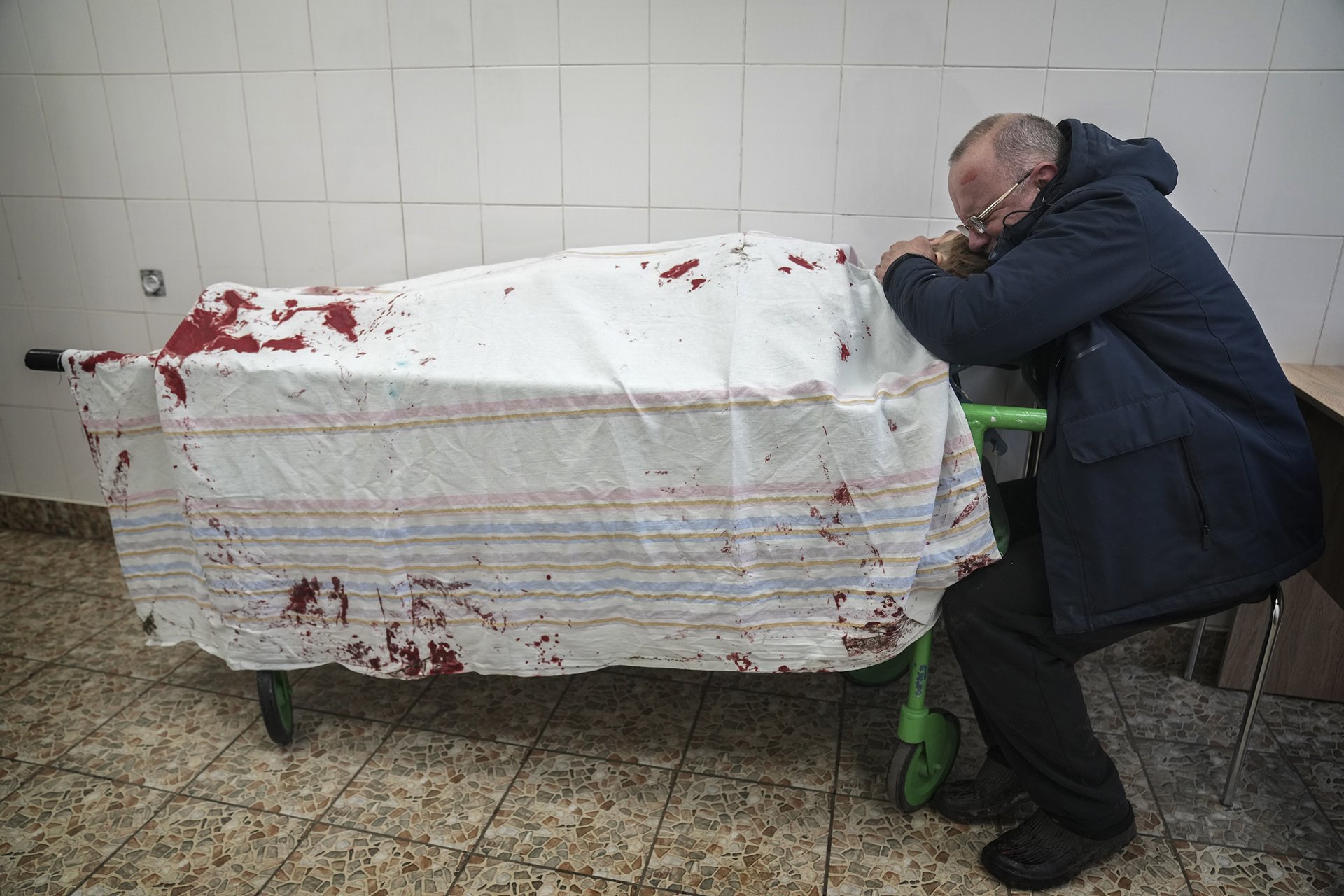 Serhii, father of Iliya (15), cries as his son&#39;s lifeless body lies on a stretcher in a maternity hospital being used as a medical emergency facility, in Mariupol, Ukraine. Iliya was playing football with his friends when a missile hit the field. His friends David and Artem were severely injured.
