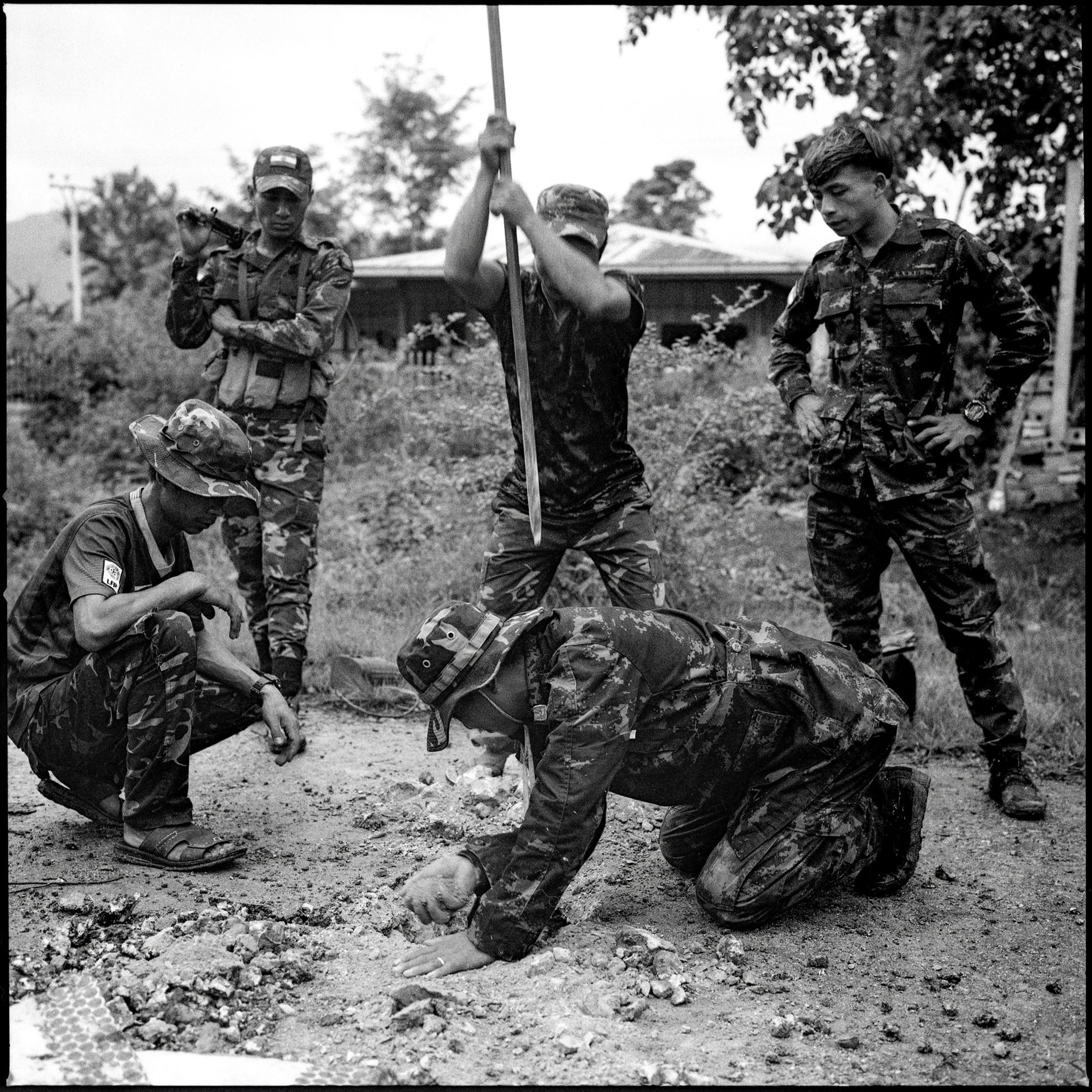 Karenni Army (KA) combatants dig up asphalt to plant homemade improvised explosive devices (IEDs) along the main Demoso&ndash;Hpruso road, in Kayah (Karenni) State, Myanmar. For two months, the Myanmar military has been trying to gain control of the highway, which was strategically important for ammunition supply.