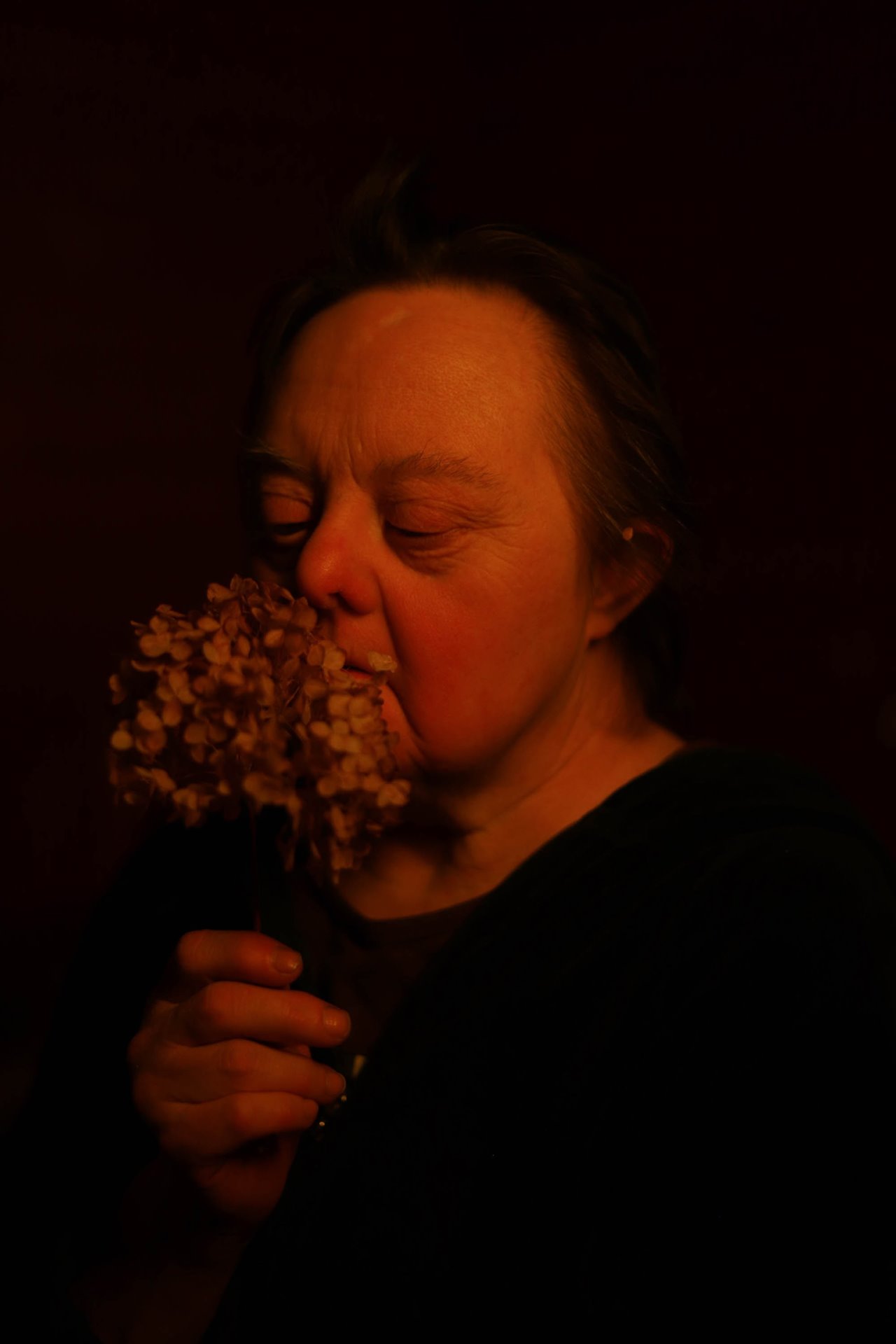 Tatyana enjoys the scent of a posy of flowers. She is one of the most independent people with Down syndrome living in Svetlana.&nbsp;