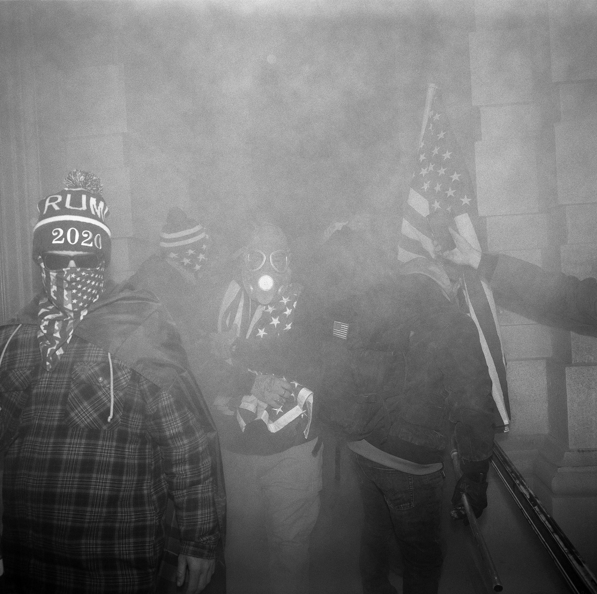 Pro-Trump protesters breaching the Capitol in Washington DC, USA are seen in a cloud of tear gas, pepper spray and dust from fire extinguishers, which were used as weapons against police at the North Entrance to the building.