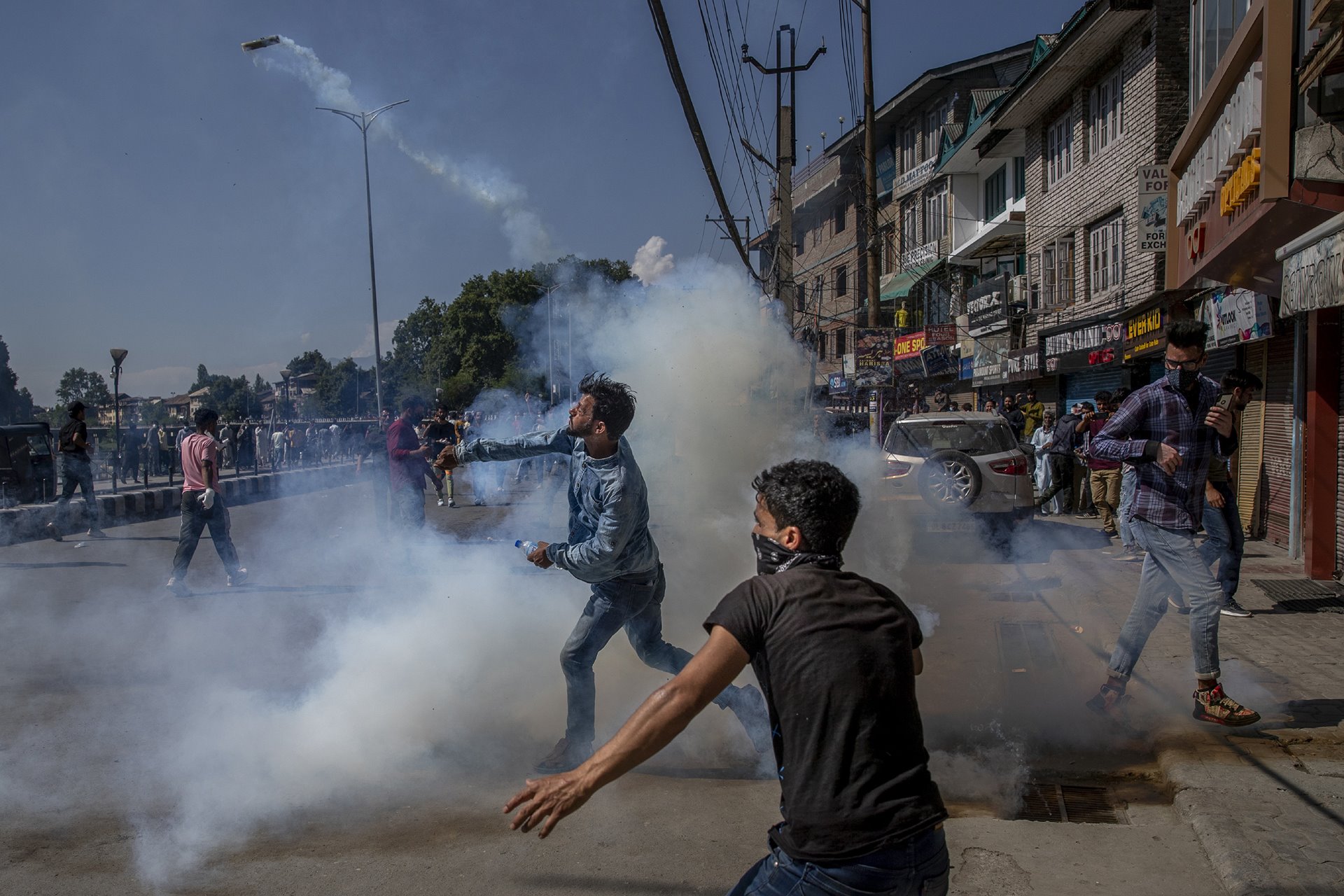 A man throws back a tear-gas canister fired by Indian police during a religious procession in central Srinagar, in Indian-administered Kashmir. Police fired tear gas and warning shots to disperse hundreds of Shia Muslims, while detaining dozens who attempted to participate in processions marking the holy month of Muharram.