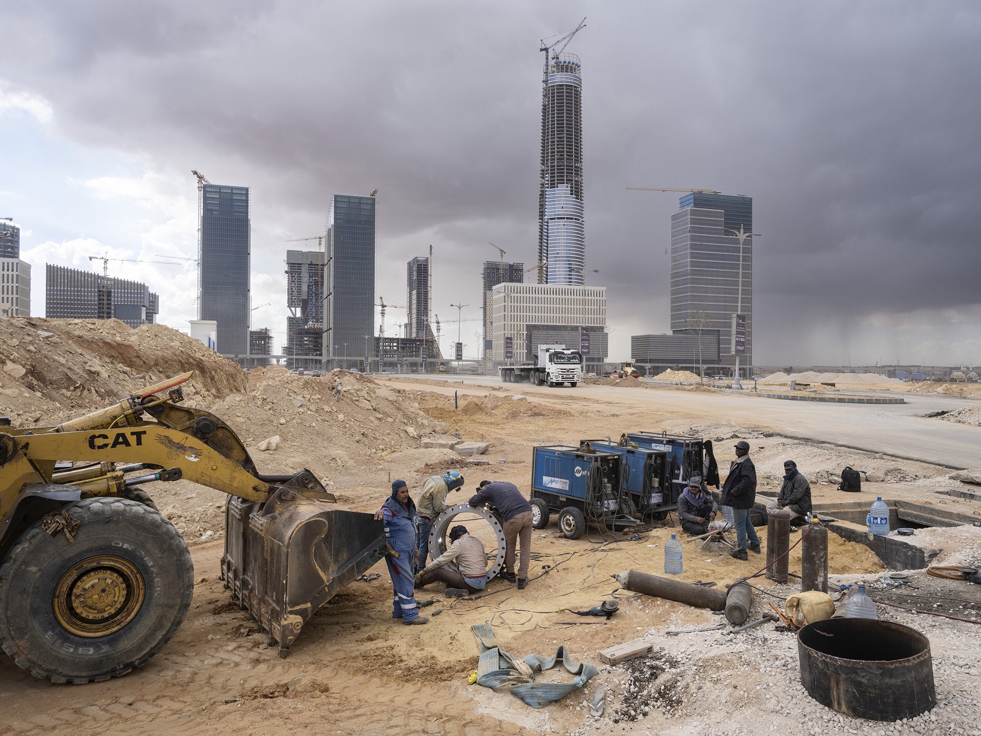 <p>Welders work near the future Central Business District of Egypt&#39;s New Administrative Capital, under construction near Cairo. The Iconic Tower (center) will be Africa&rsquo;s tallest building, at 394 meters high.</p>
