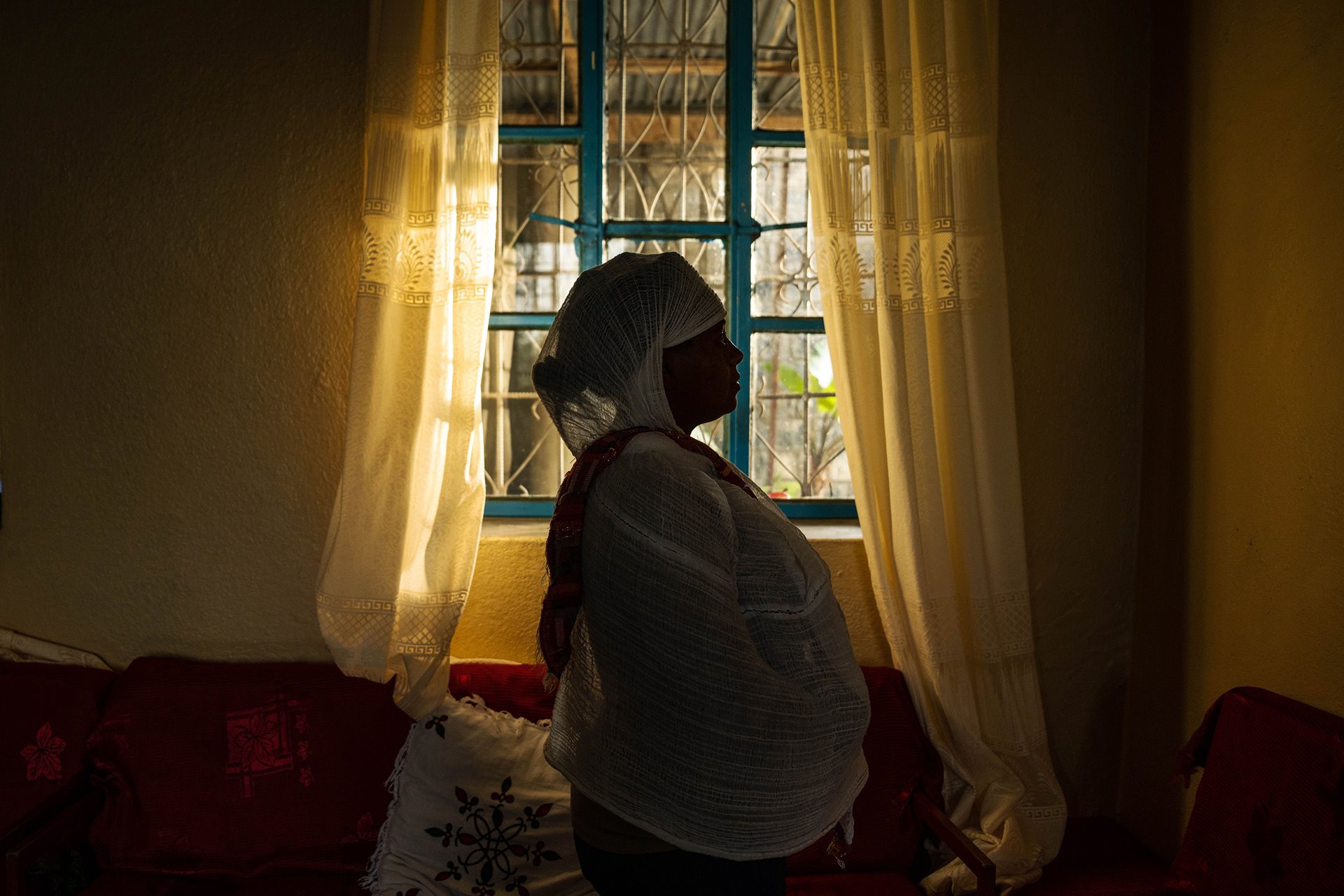 A portrait of a 28-year-old survivor of sexual violence in Mekele, Ethiopia. During the Tigray war she was raped by two Eritrean soldiers who killed an older Muslim man who tried to intervene on her behalf. Her brother-in-law, who witnessed the assault and helped her find treatment, died later in the war. She lives in fear that her husband will find out she was assaulted.