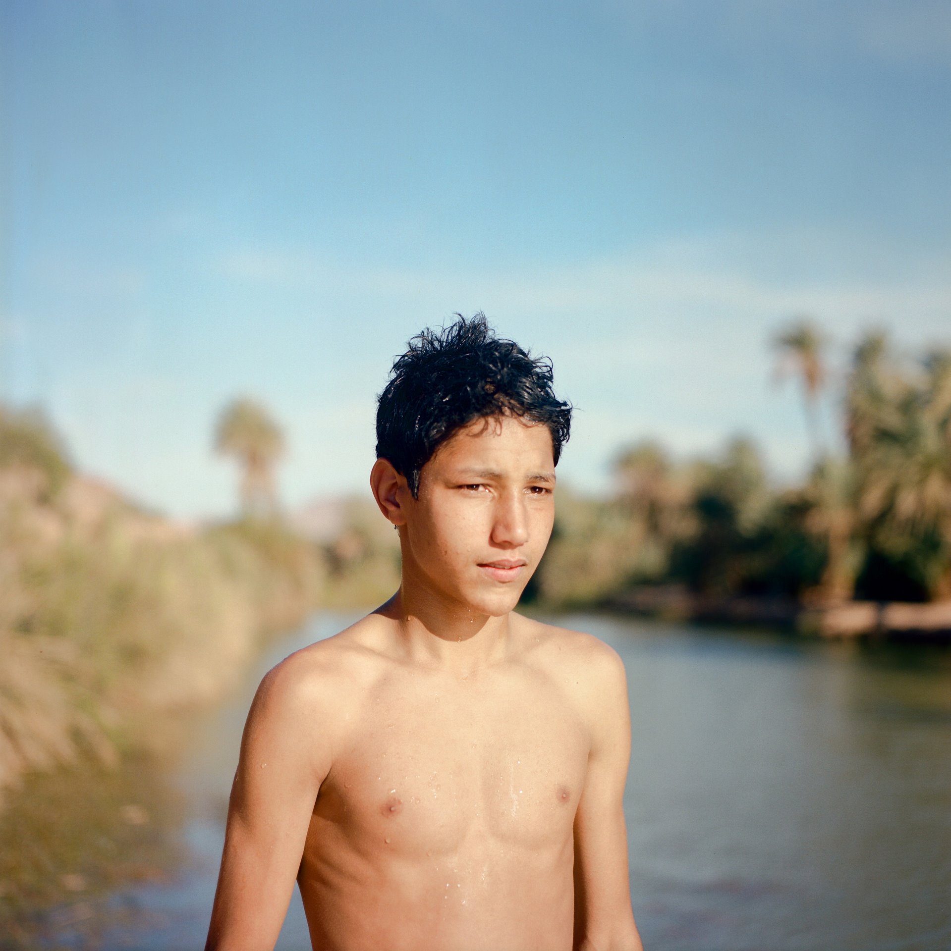 Mustapha (14), who lives at Taghjijt Oasis in southern Morocco, has dropped out of school to help on the family farm. He enjoys swimming with friends when work is finished, and would like to continue working as a farmer.