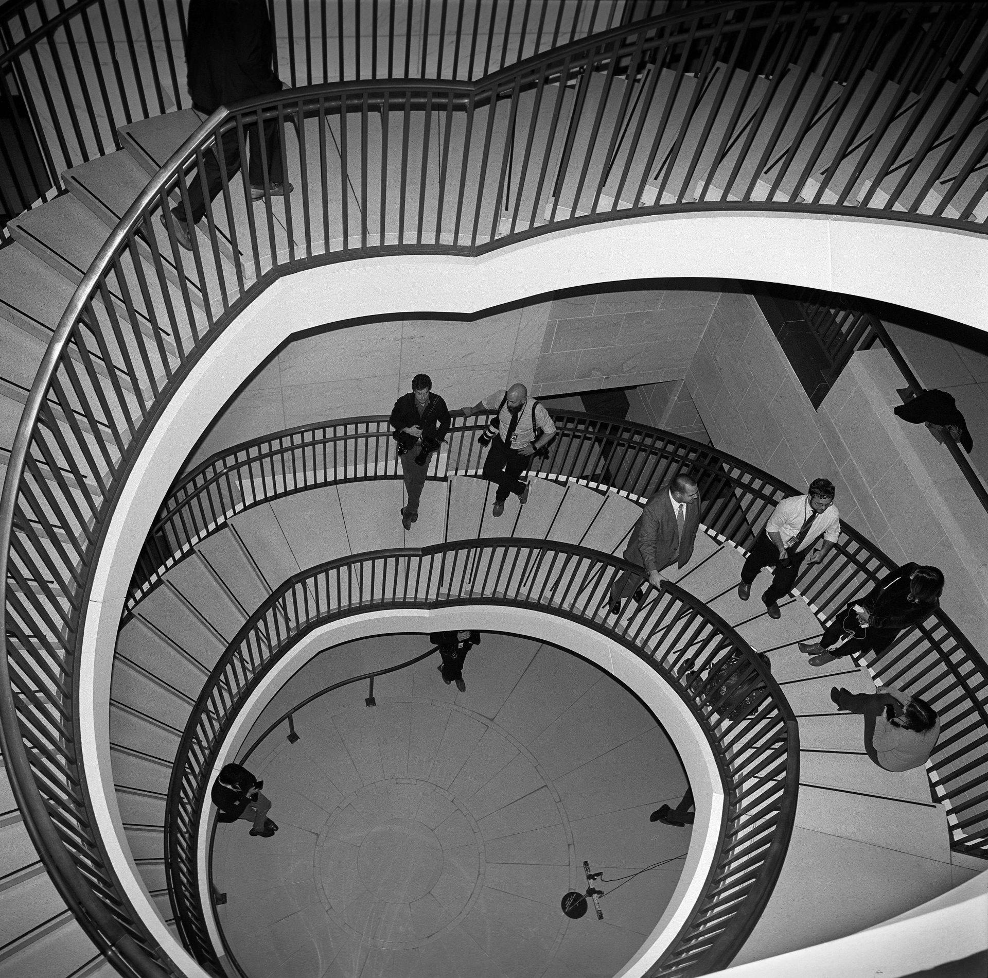 Journalists wait on a staircase that leads to the Sensitive Compartmented Information Facility, in Washington DC, USA, where the House Intelligence Committee heard from witnesses while deciding whether to impeach President Trump. Witnesses entered from the top and exited at the bottom, so journalists chased them up and down the stairs to interview and photograph them.&nbsp;